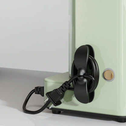 Black appliance cable organizer attached to a kitchen air fryer for neat cord management