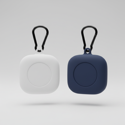 White and navy blue silicone cases for Tile Mate tracker with black carabiner clips on light grey background